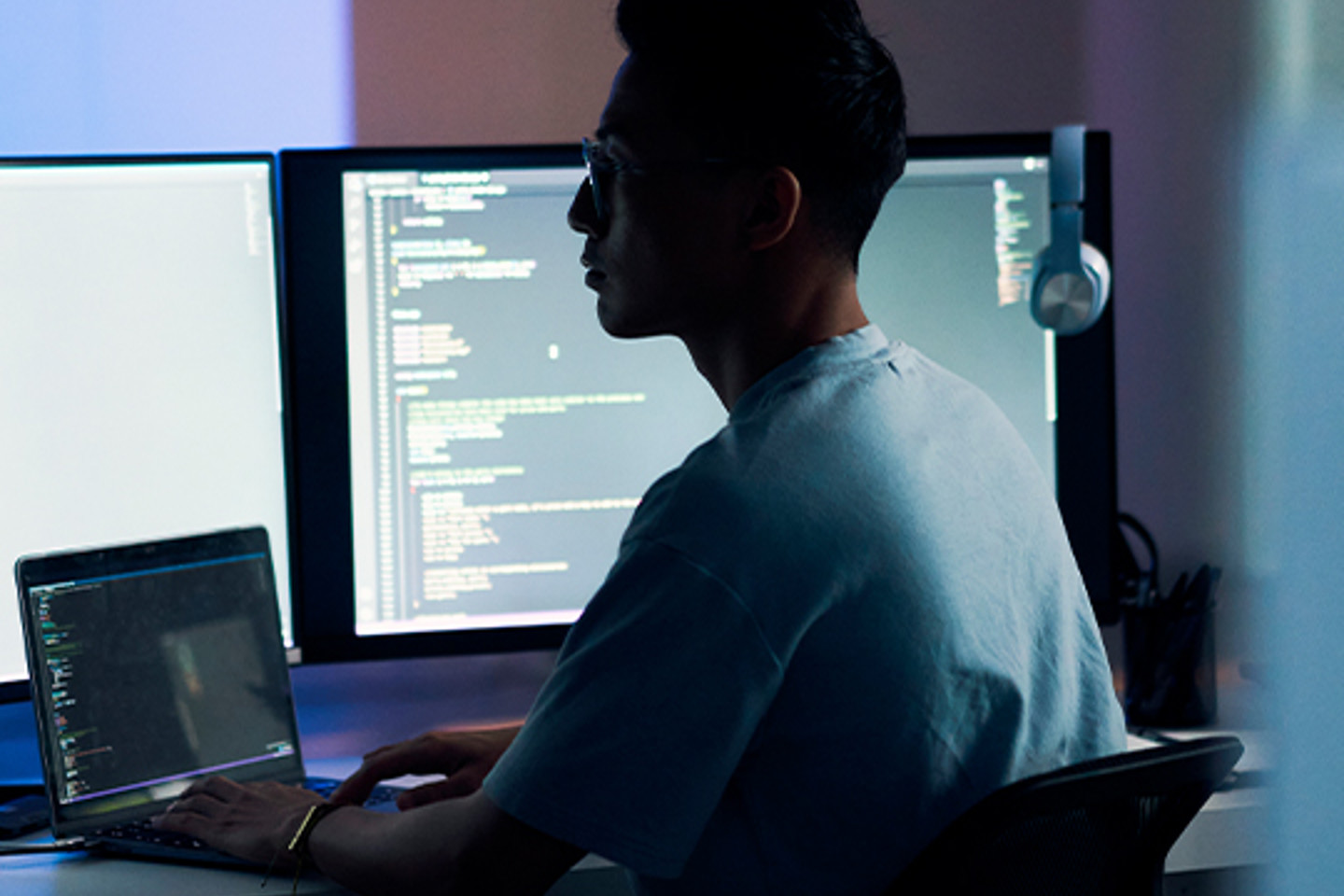 Scorpion Portrait 3 man working on laptop and monitors in dark