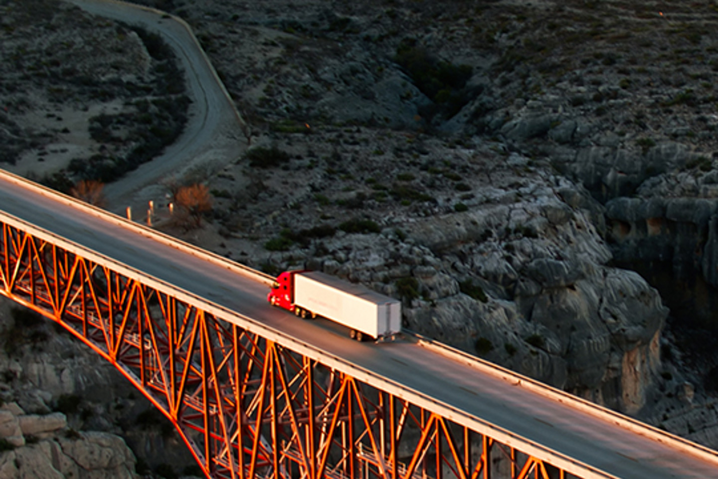 Truckstop Com Portrait 3 truck on bridge