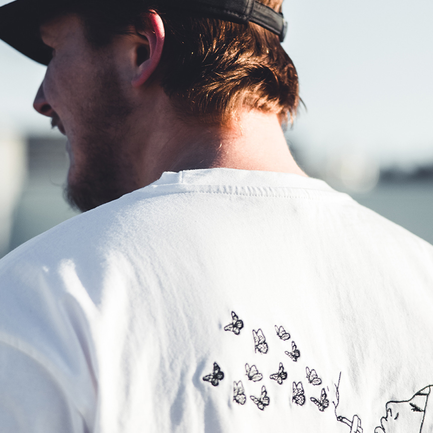 Printful Header 2 Man in tshirt and cap