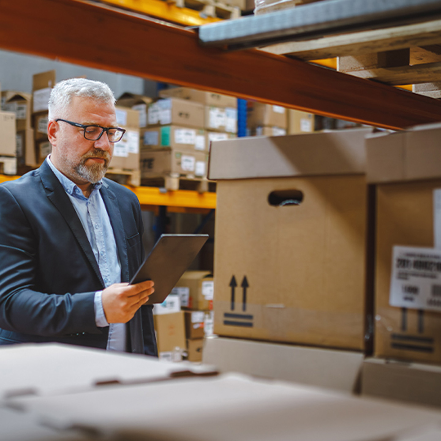 Procure Analytics Portrait 2 man working on tablet in warehouse