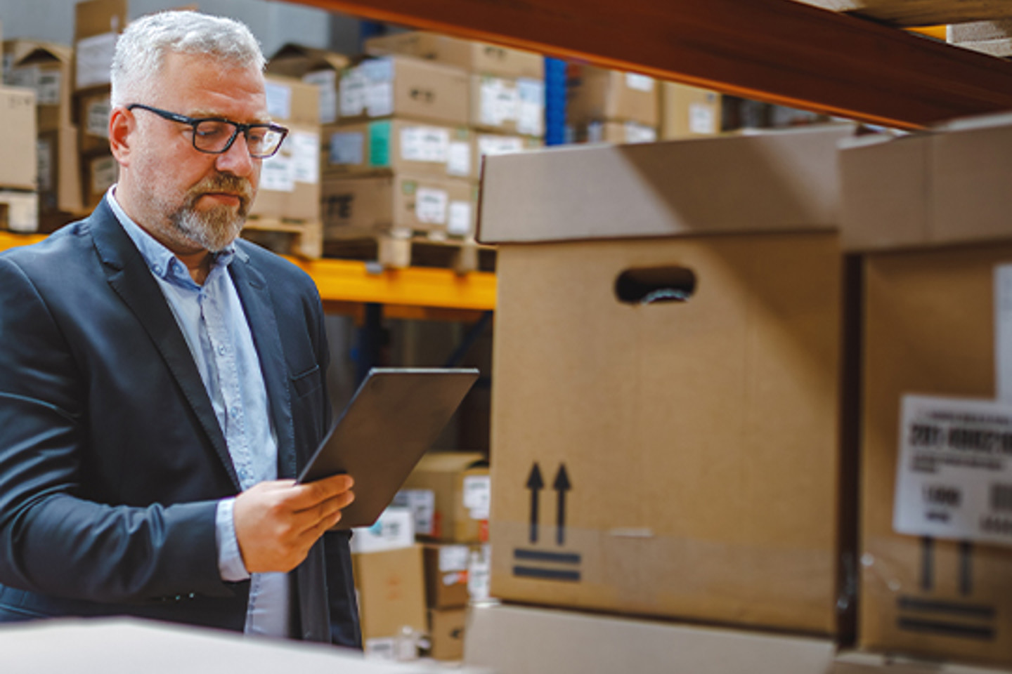 Procure Analytics Portrait 2 man working on tablet in warehouse