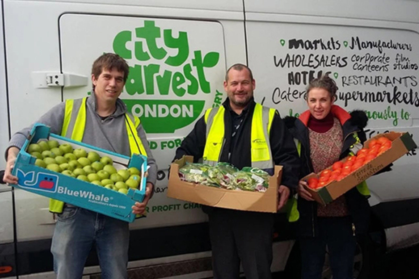 volunteers holding trays of food