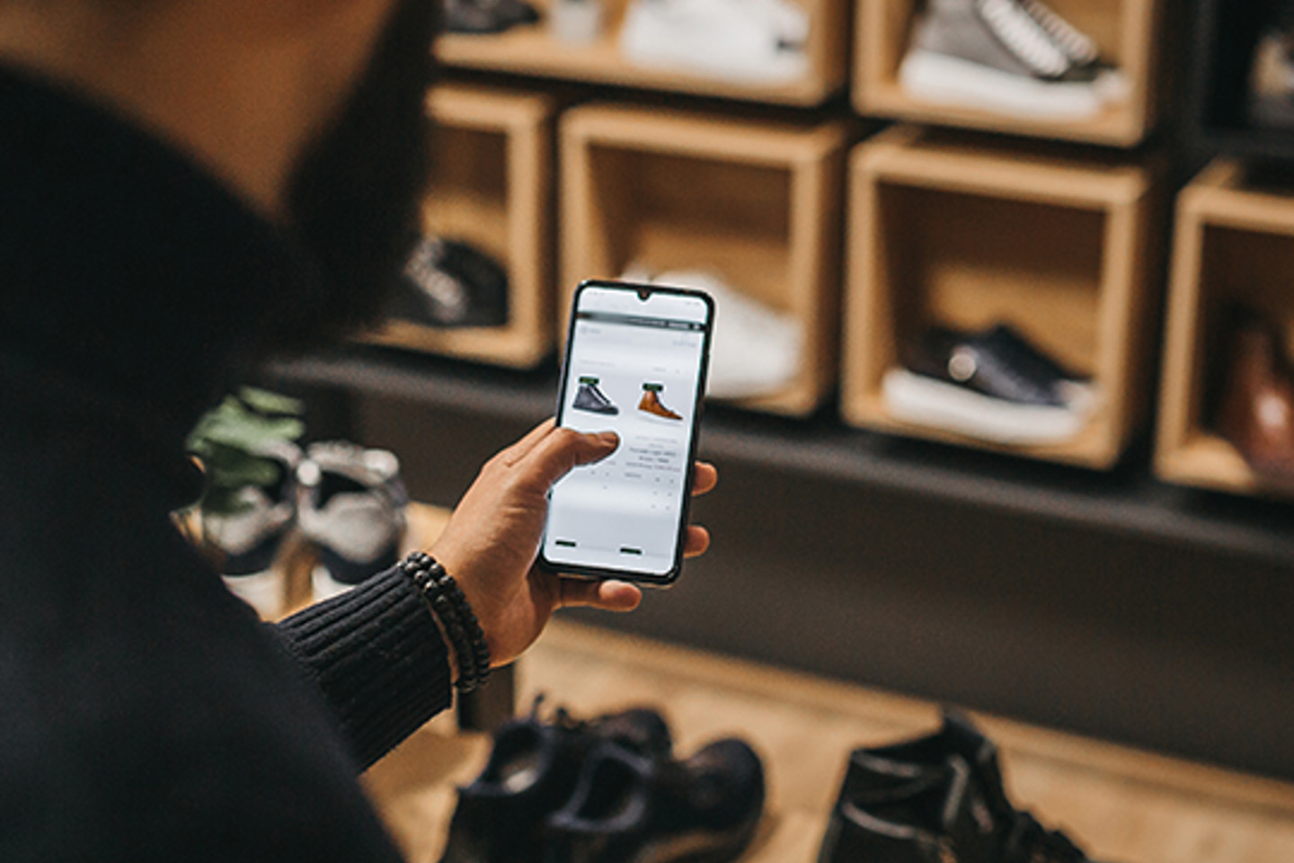 Uberall Portrait 3 man on phone looking at shoes