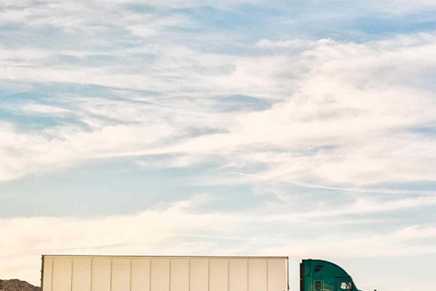 Transflo Portrait 2 truck driving through desert landscape