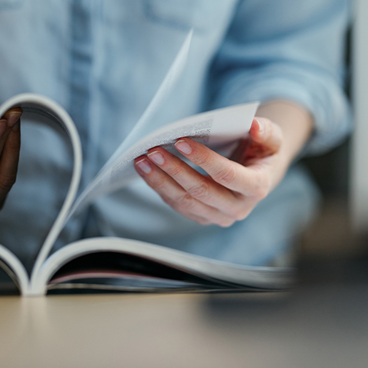 MEDIA Central Portrait 3 hands flipping through books