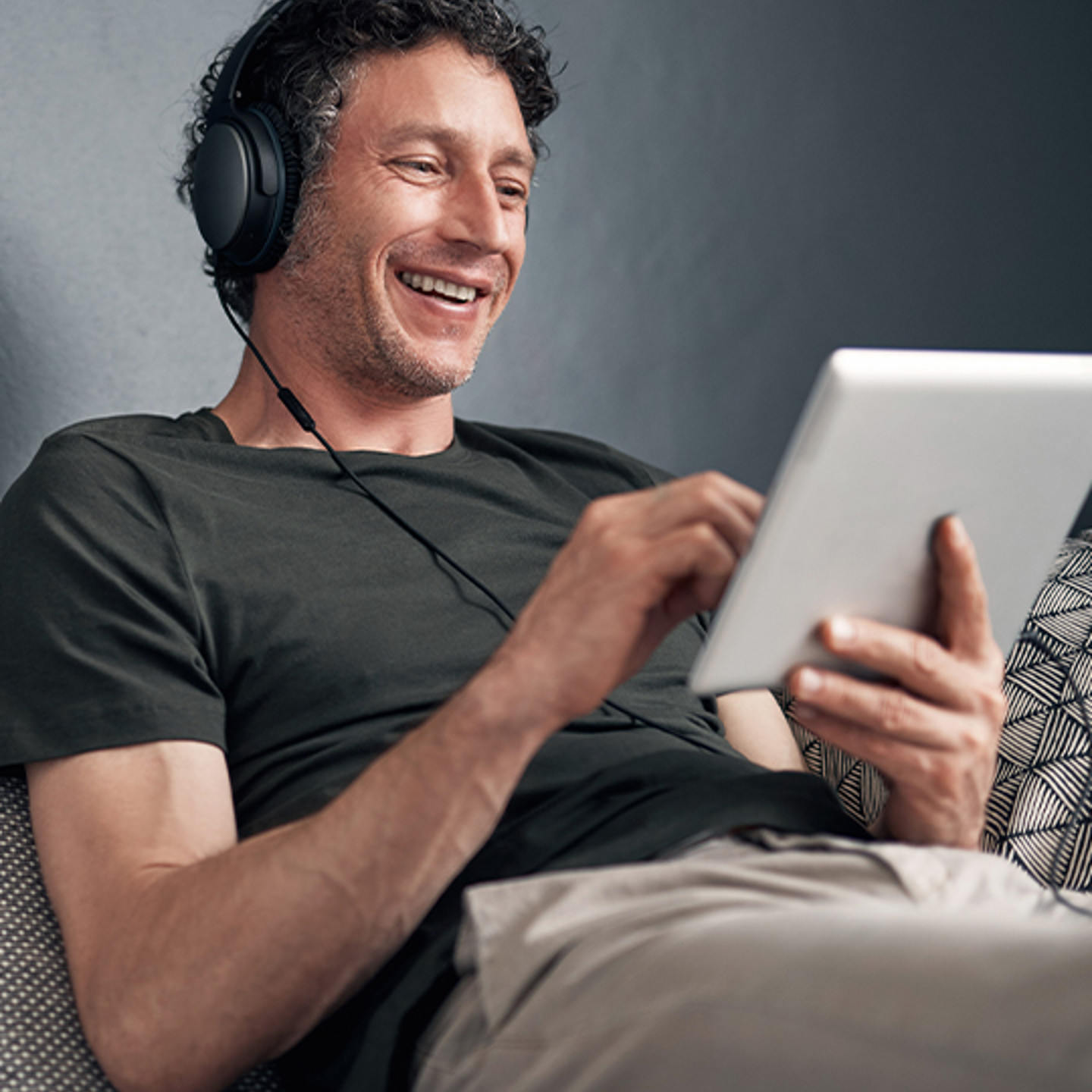 AMG Portrait 1 man smiling at tablet