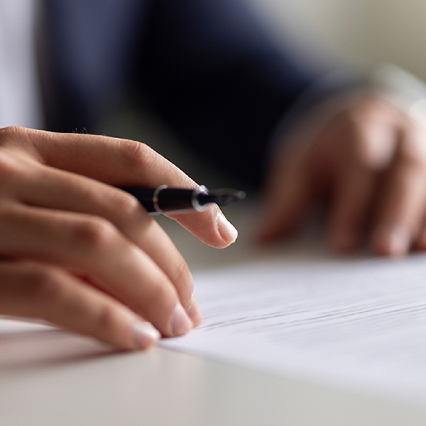 Sureprep Portrait 3 hands holding pen over paperwork