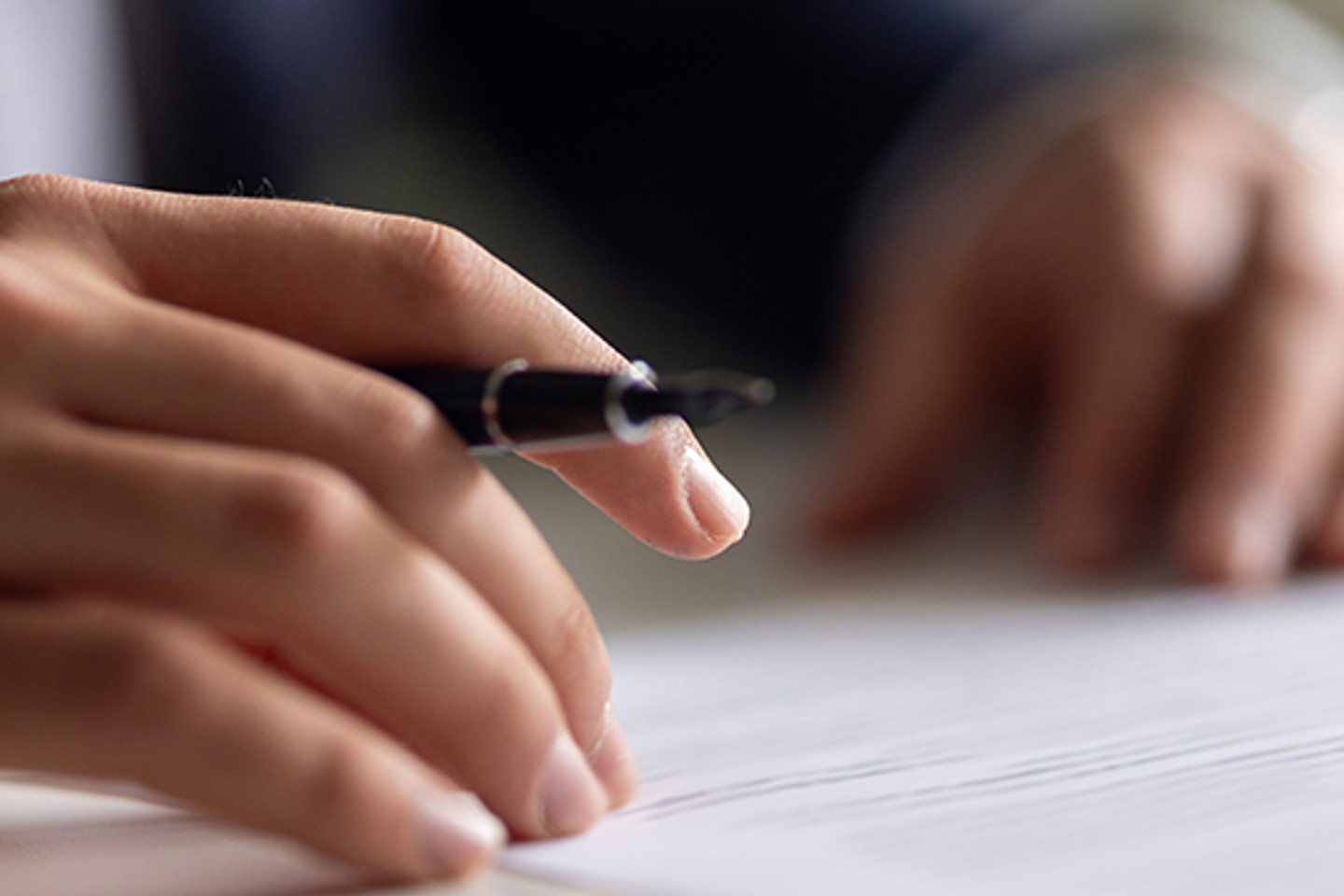 Sureprep Portrait 3 hands holding pen over paperwork
