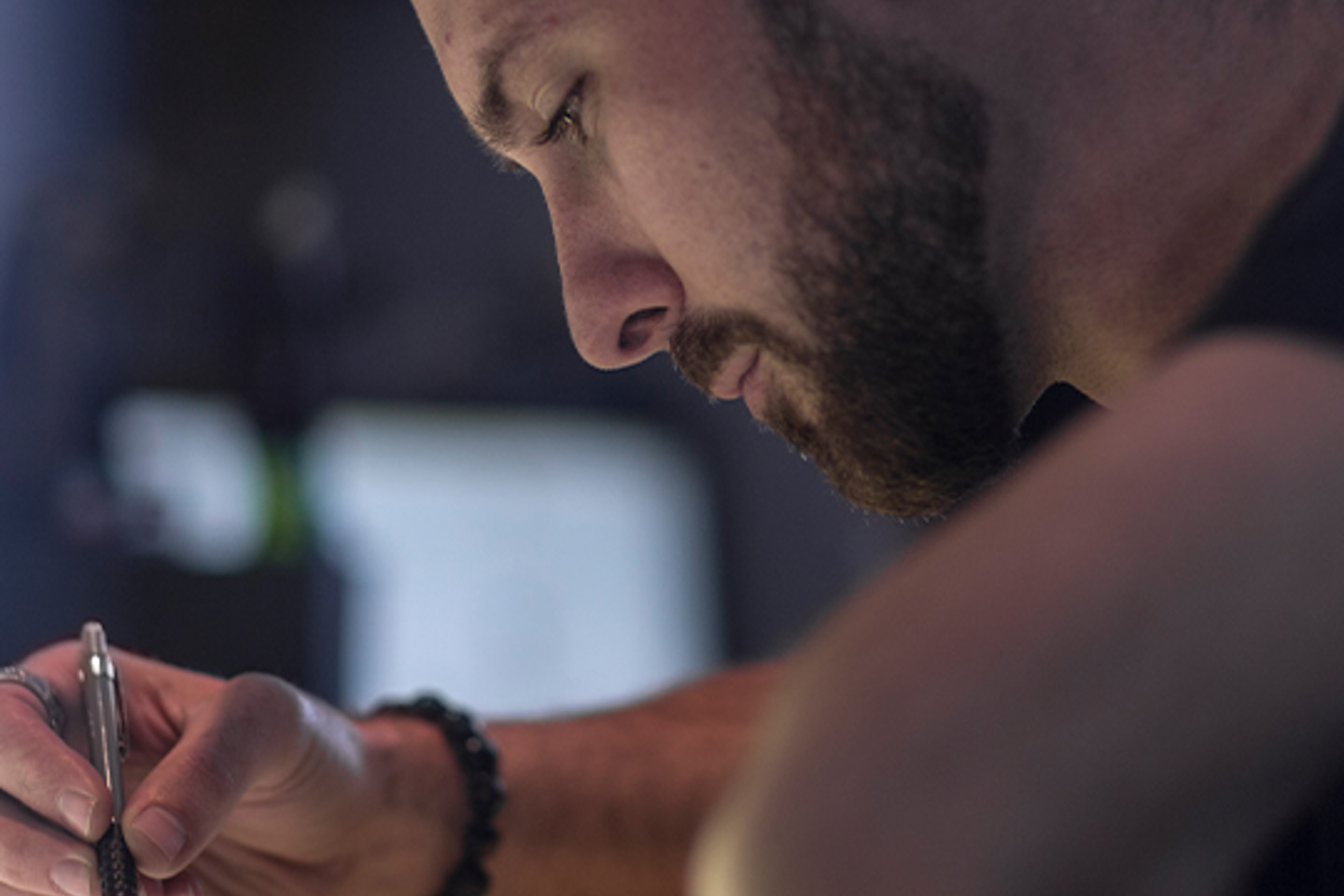 Orangelogic Portrait 1 man using pen