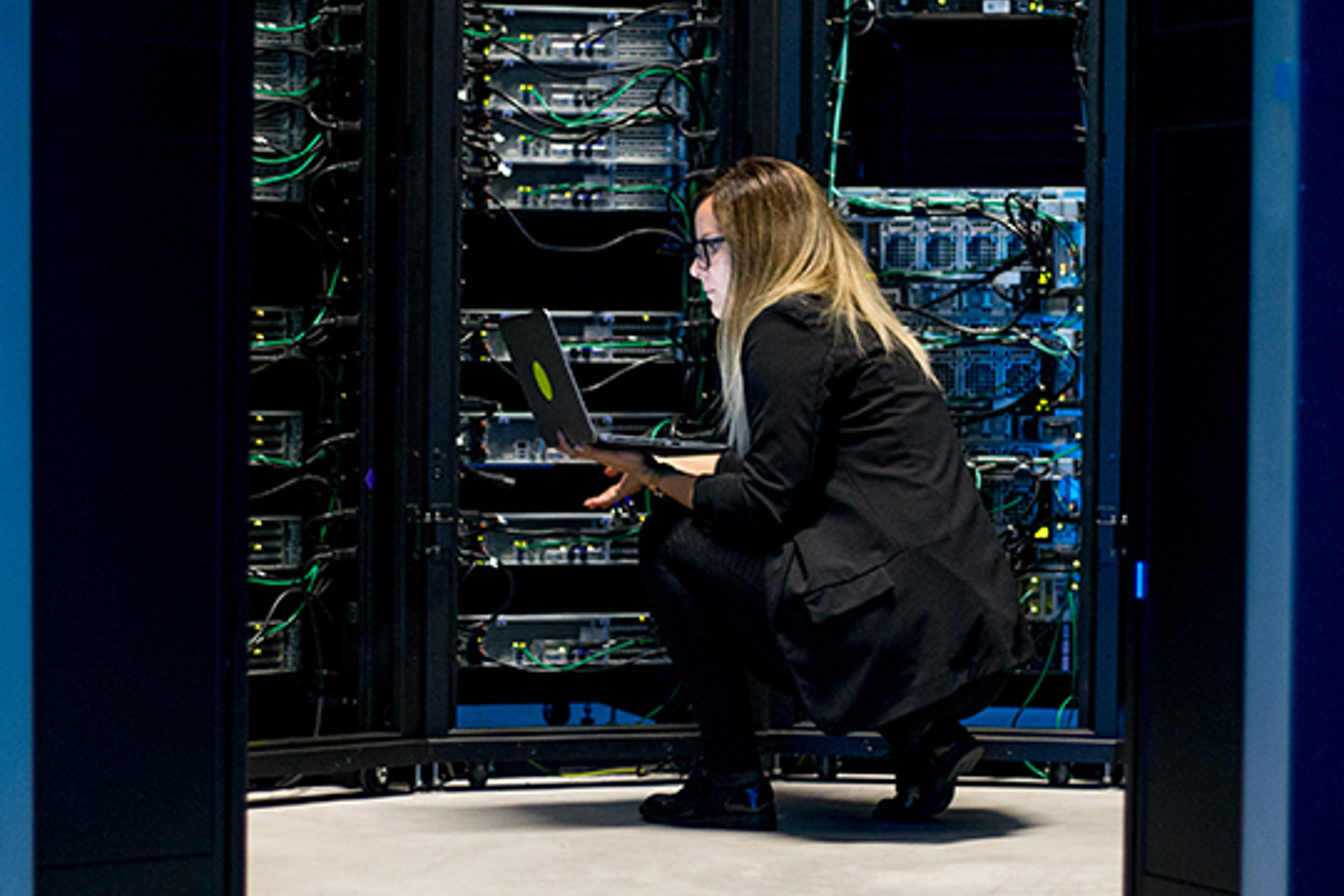 Connectria Portrait 2 woman crouching around servers