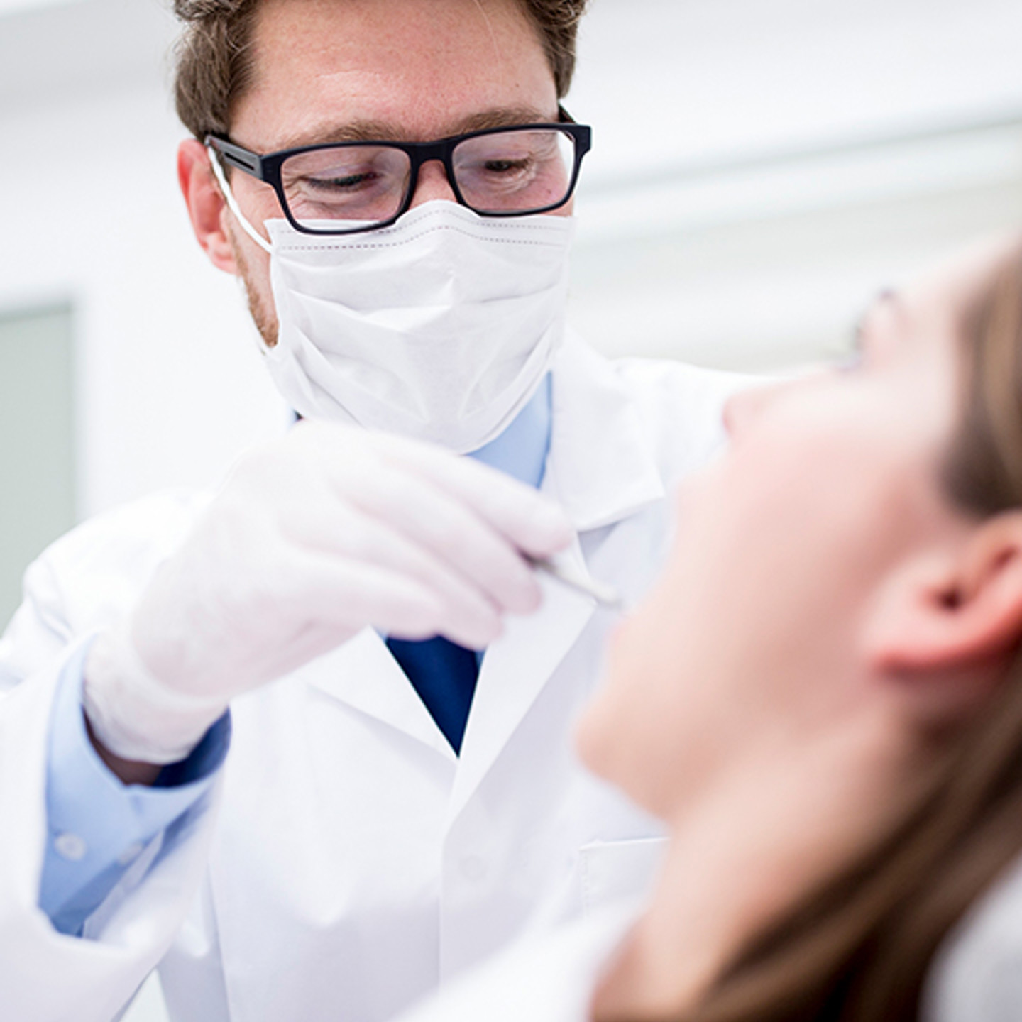 Dentalxchange Portrait 1 Dentist looking at patient's mouth