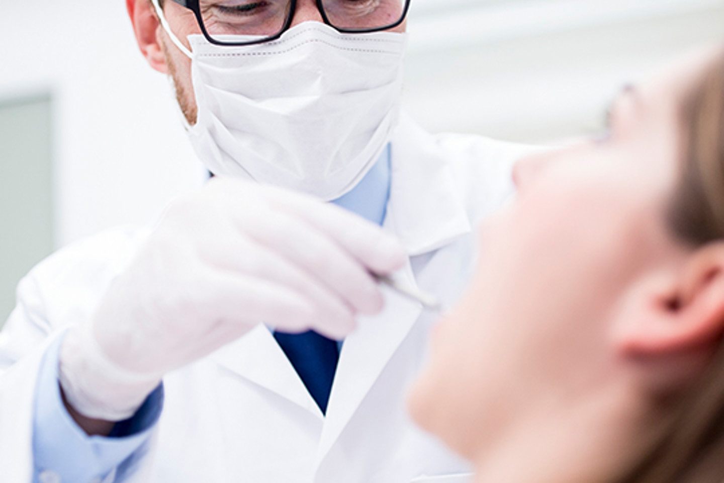 Dentalxchange Portrait 1 Dentist looking at patient's mouth